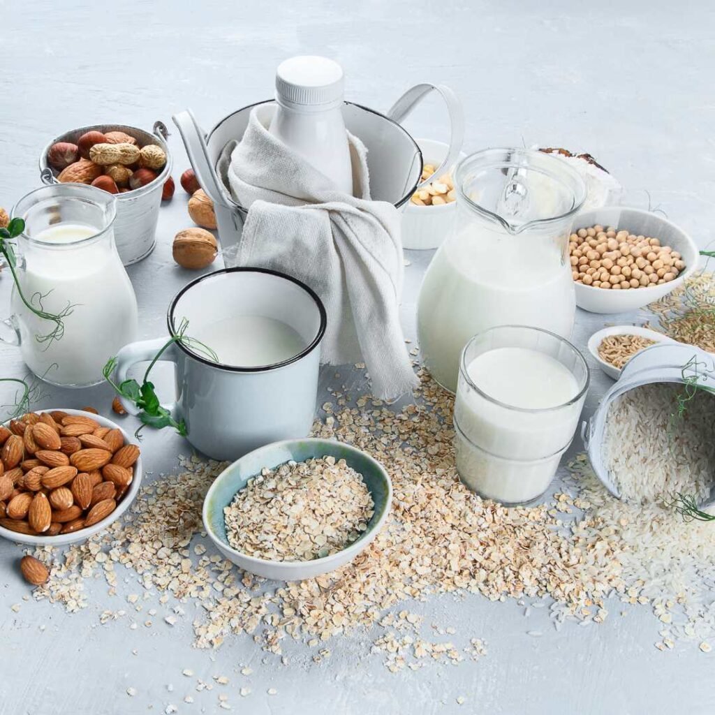 Different dairy products showcased, including plant based milk, assorted nuts, and cereal, arranged attractively for viewing.